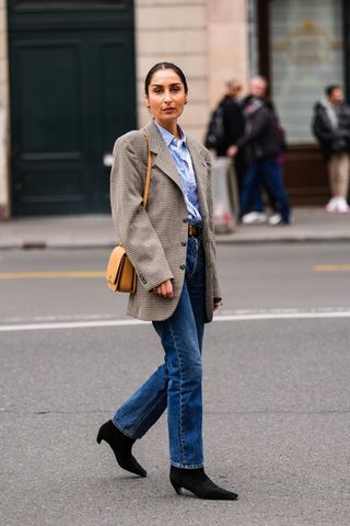 A stylish woman wearing straight leg jeans and a blazer