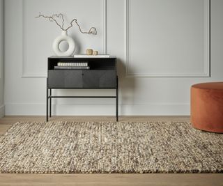 cream and stone coloured large rug on wooden floor