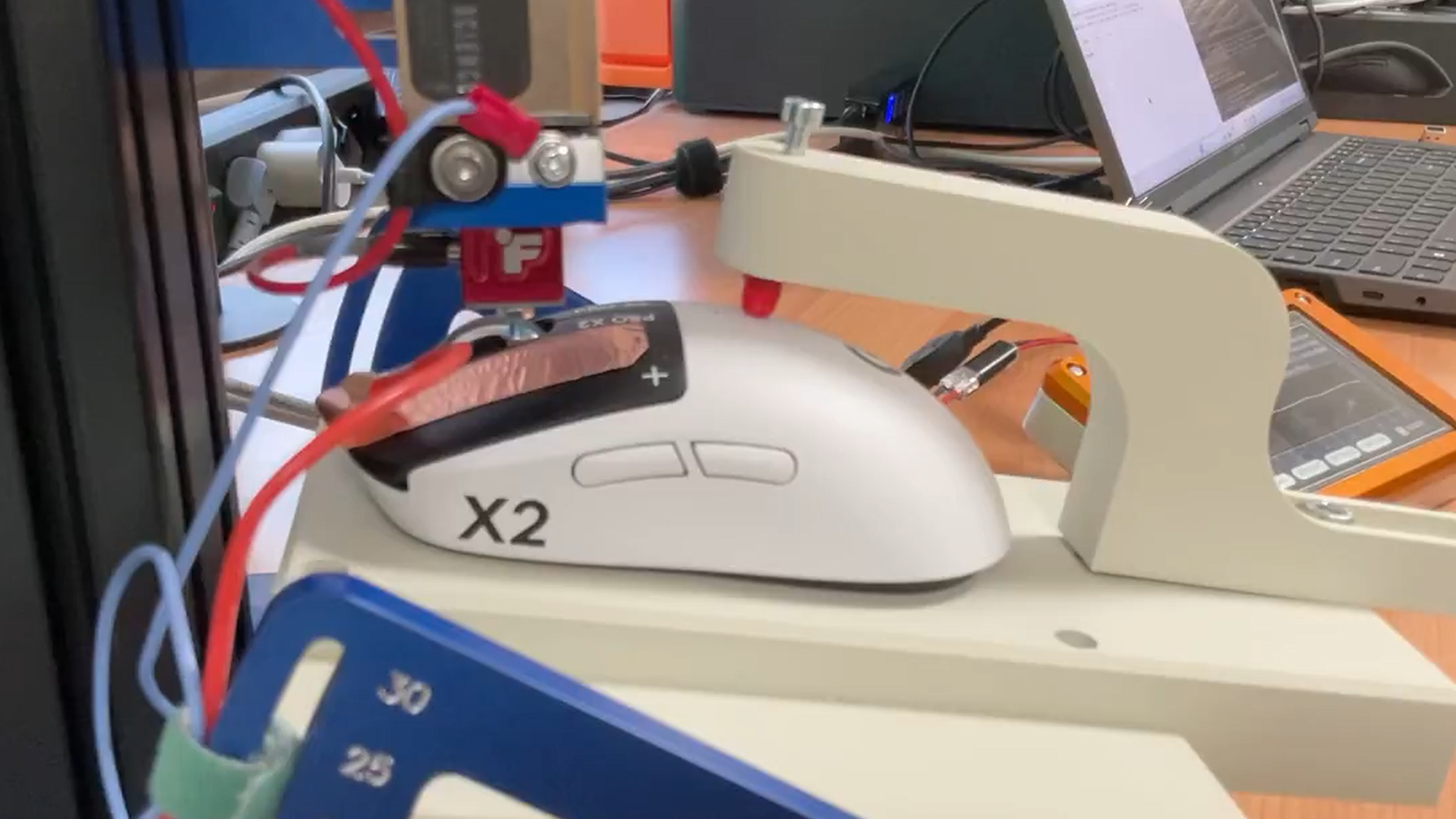 A Logitech G Pro X2 Superstrike's mouse click speed being tested on a machine by Finalmouse.