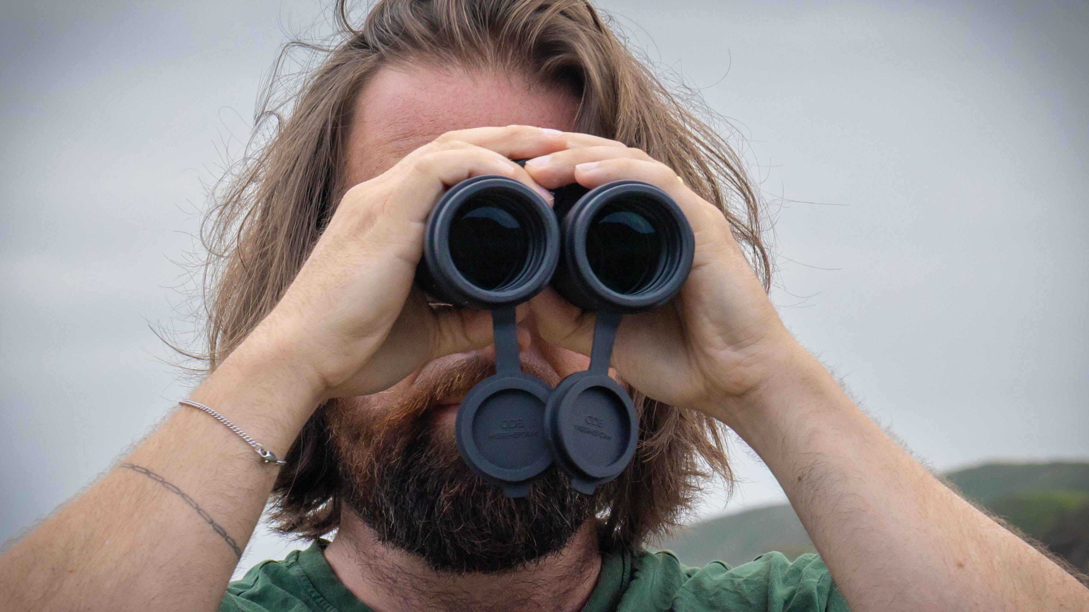 A close-up of a male using the Nikon Monarch M7 8x42 binoculars.