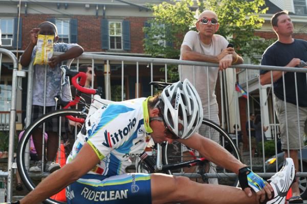 Spectators watch Clay Murfet (RideClean-PatentIt.com) stretch and warm up before the race.