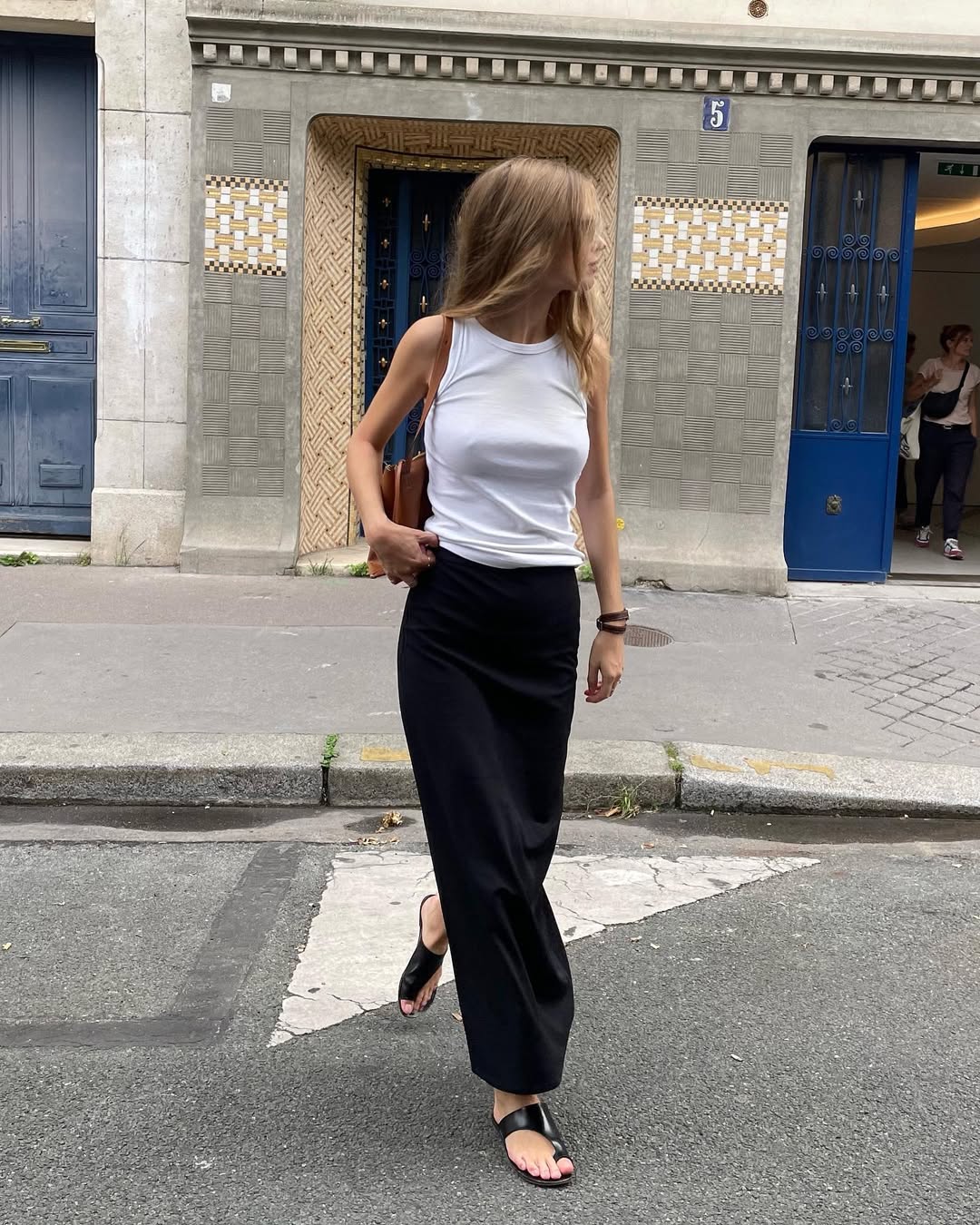 Clara in black toe-wrap sandals and skirt