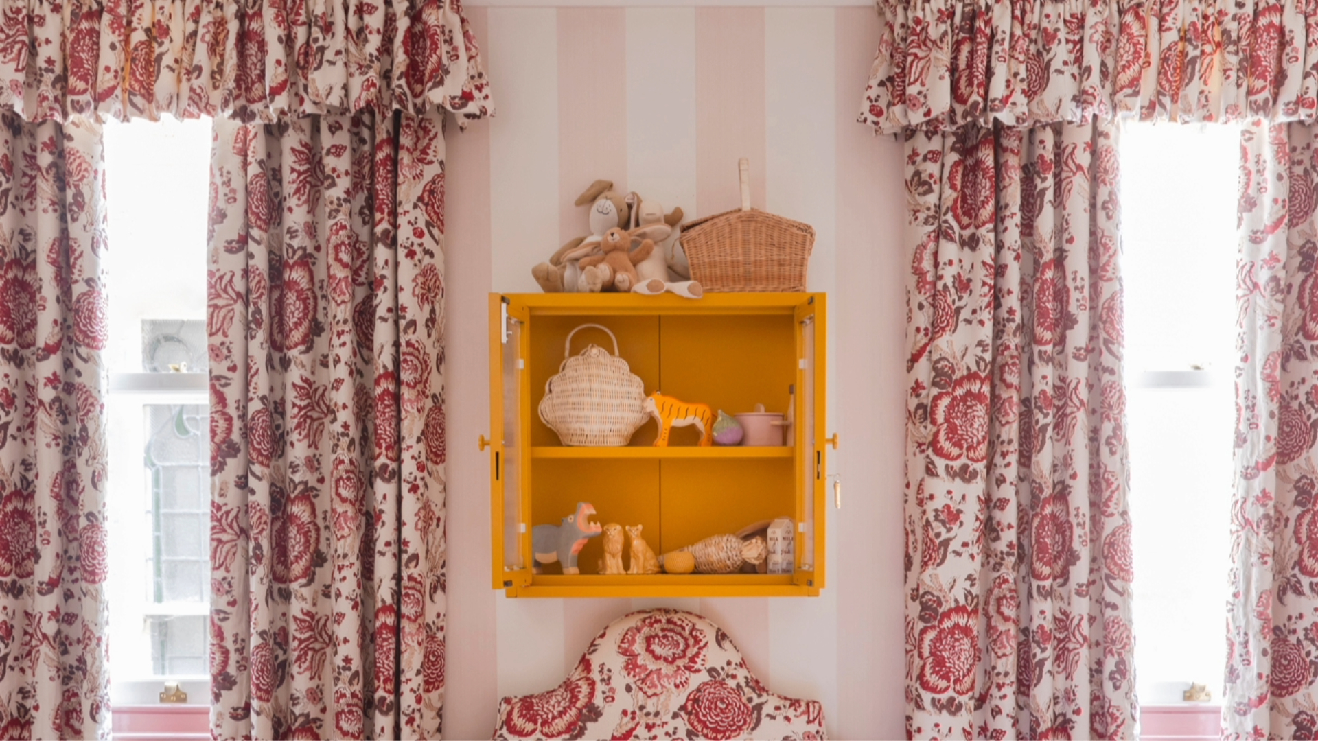 Yellow cabinet in chintzy bedroom