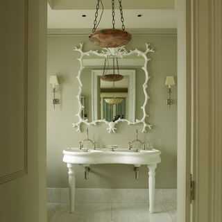 White bathroom mirror with frech basin and cream walls