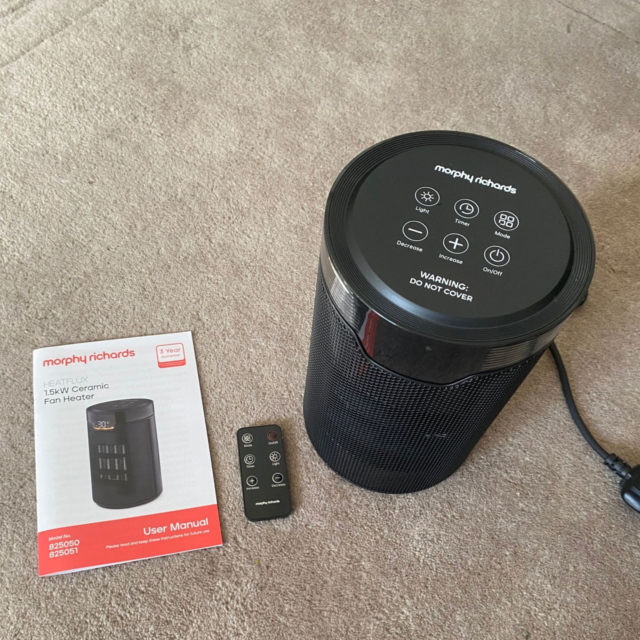 Morphy Richards HeatFlux 1.5kW Ceramic Fan Heater, remote control and instruction manual laid out on a neutral rug