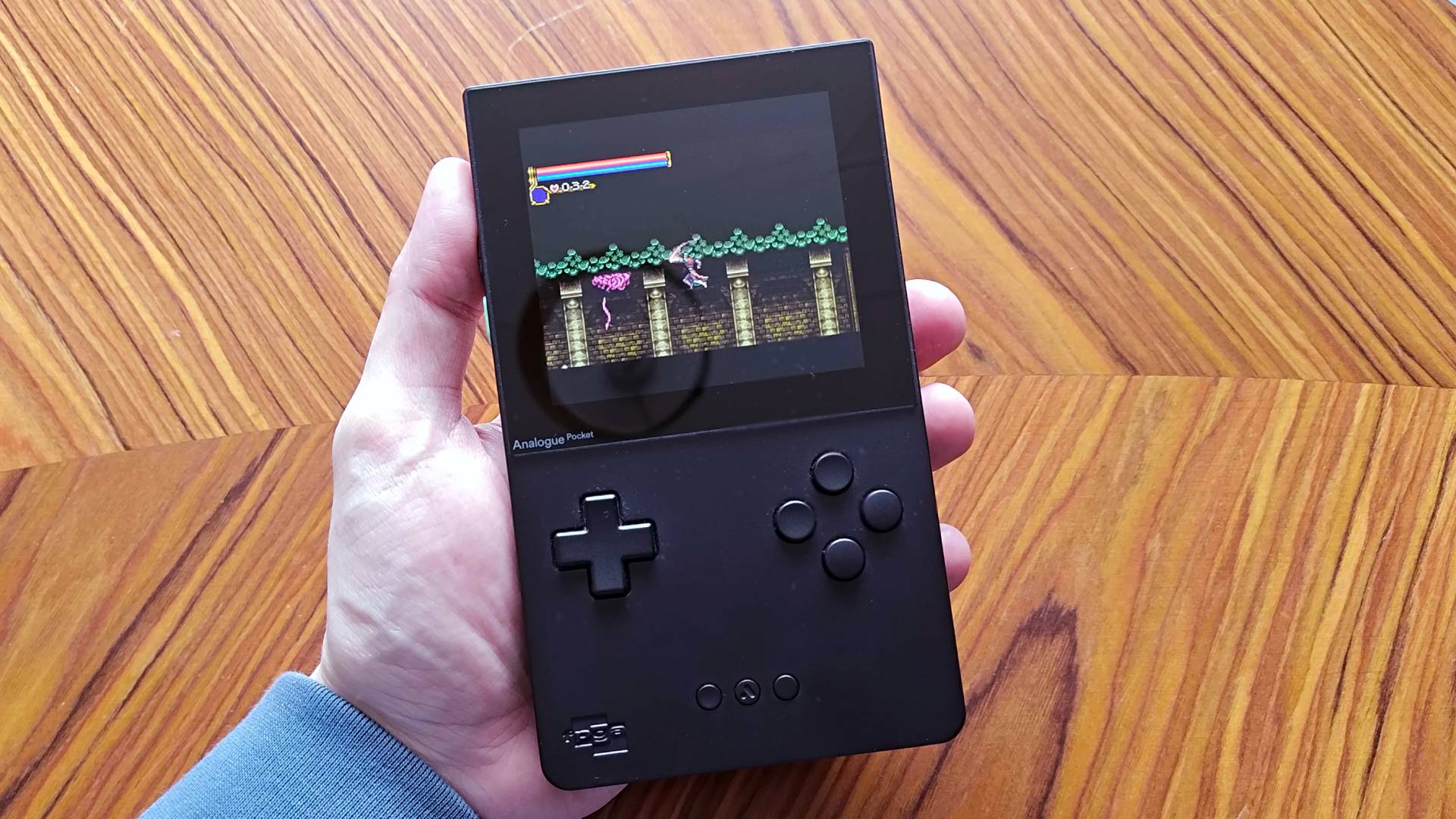Hand holding Analogue Pocket with Castlevania gameplay on screen.