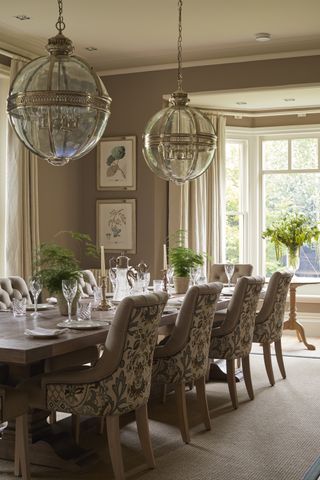 grey dining room with patterned chairs, botanical art and glass pendant lighting by Sims Hilditch