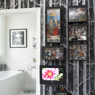 bathroom with black wall with white texture and picture frame and bathtub
