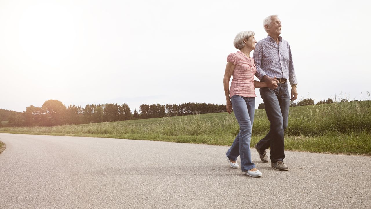 A senior couple walking along a path 