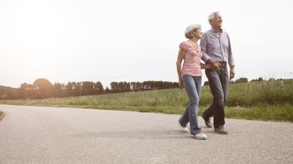 A senior couple walking along a path 