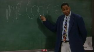 Mark Curry gestures to his name on a chalkboard in Hangin' With Mr Cooper.