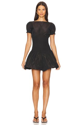Model is wearing a black short-sleeve bubble-hem dress