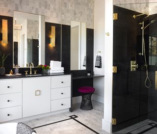 Black and white bathroom with white vanity, grey floor tiles, black walk in shower