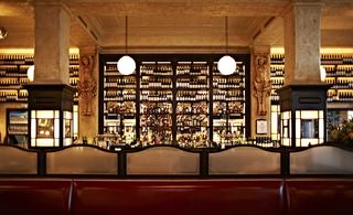 Balthazar restaurant and bar, with large buttresses, extensive wine racks and red leather banquette seating