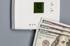 Thermostat with money in front of it.