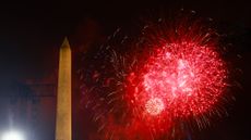 Fireworks explode behind the Washington Monument in Washington, D.C. 