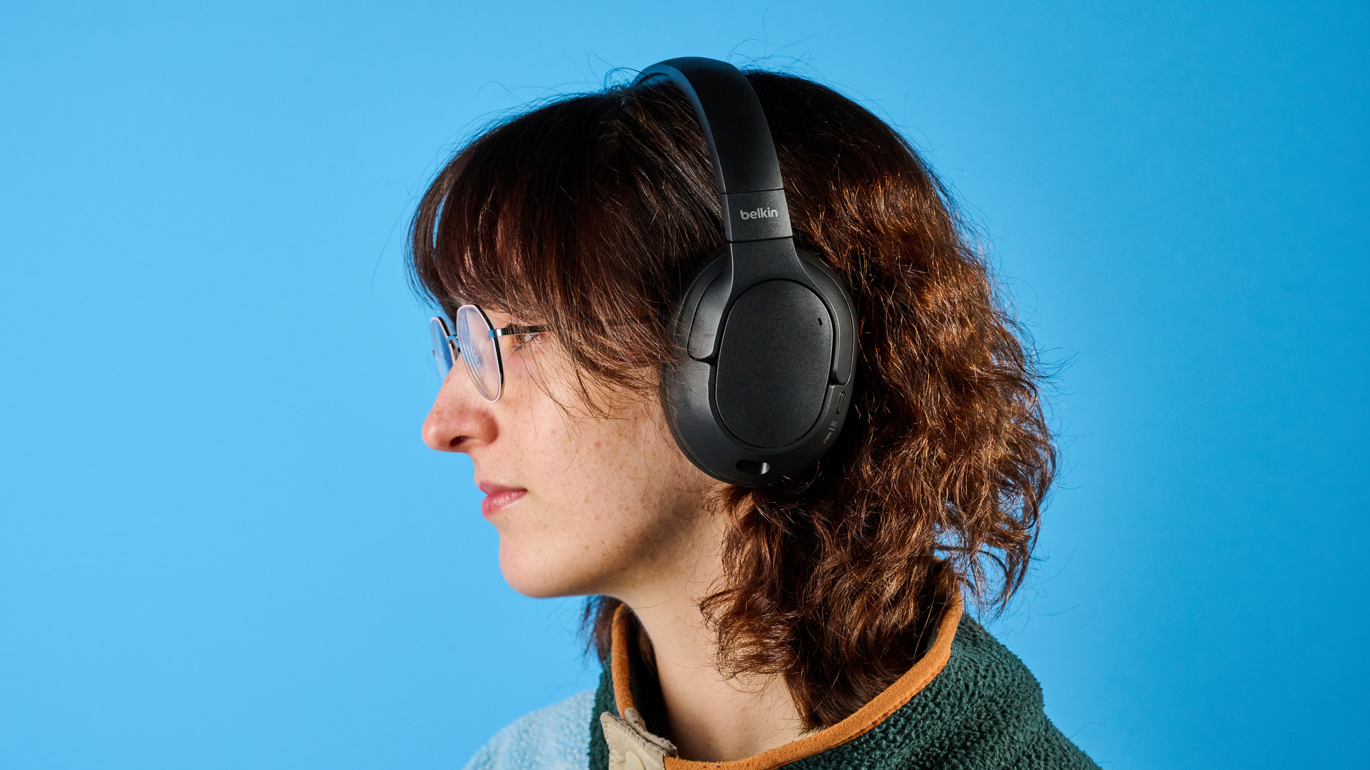 the belkin soundform isolate are a pair of budget headphones in black, with soft pillowy cups, control buttons on each cup, and ANC