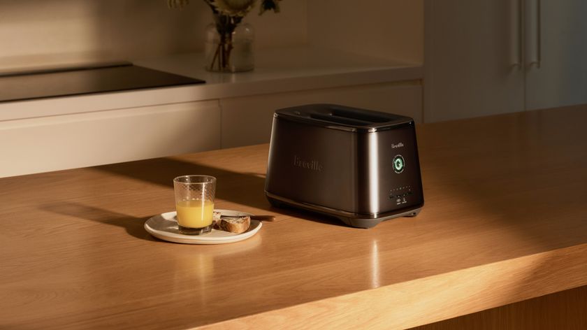 Breville Eye Q toaster beside a plate of half-eaten toast and a glass of juice