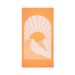 An orange beach towel with a sun and mountain illustration