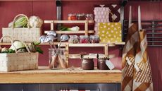 a kitchen bench with pickling supplies and vegetable in a basket