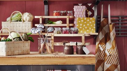 a kitchen bench with pickling supplies and vegetable in a basket