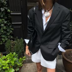 Coco Schiffer wears a black and white shorts outfit.