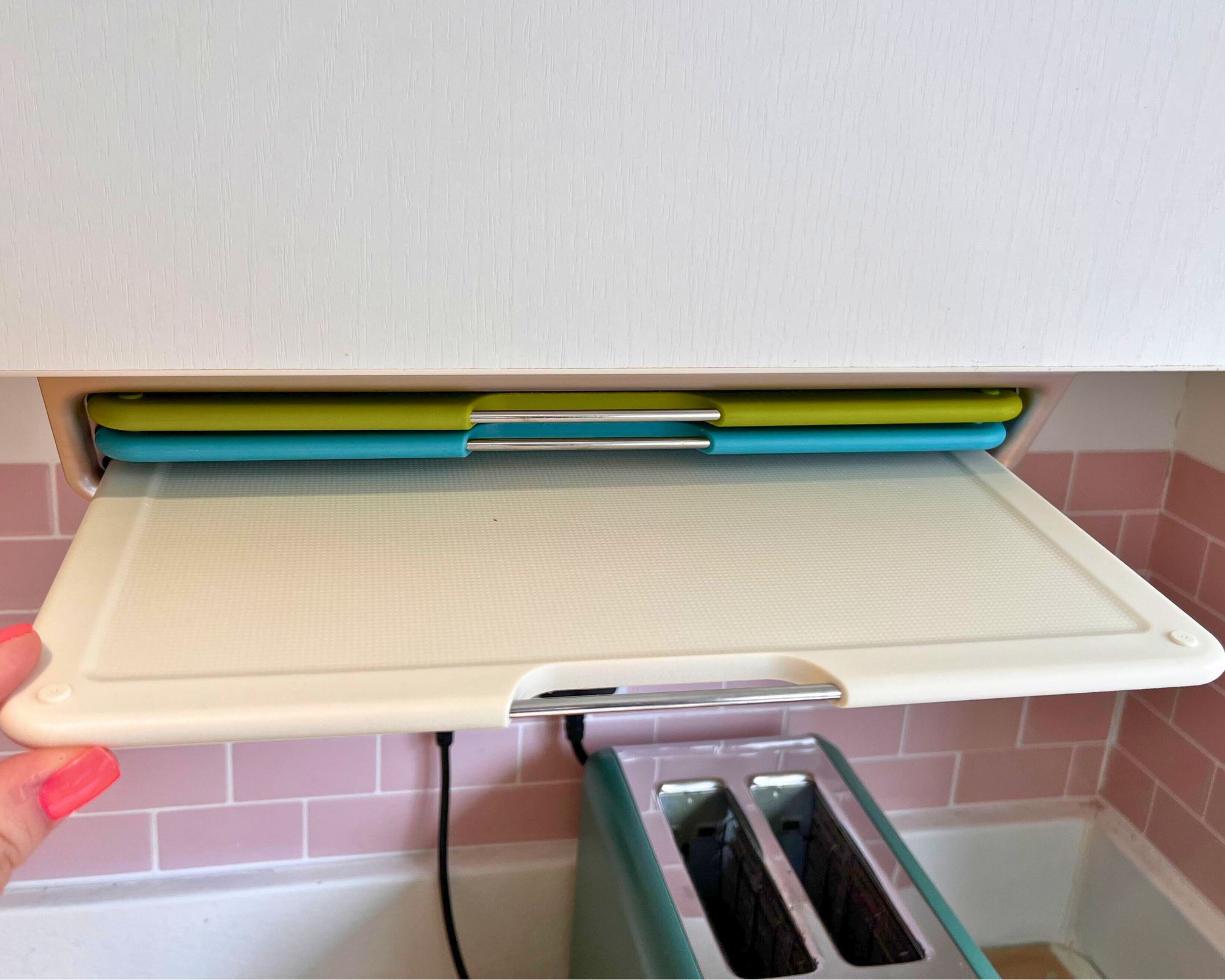 The Joseph Joseph Folio Slim Cutting Board trio in place under my cabinet