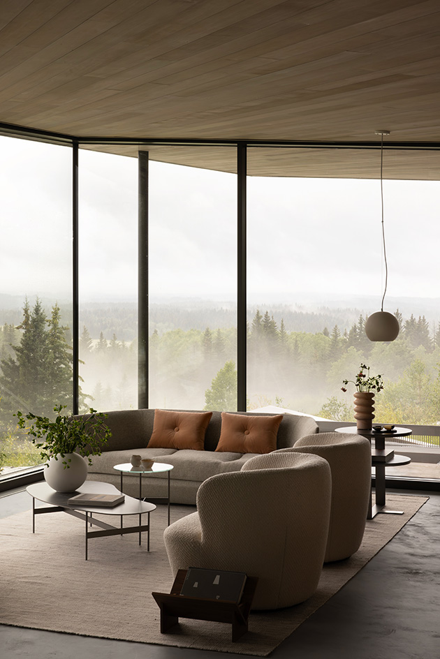 Cut Out House, a square footprint home with a round cut out set in the canadian winderness, by a lake