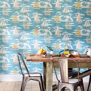 dining area with blue printed wallpaper