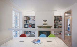 Office within the building featuring a large table and coloured chairs
