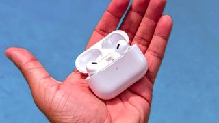 Apple AirPods Por 2 USB-C in hand over a pool
