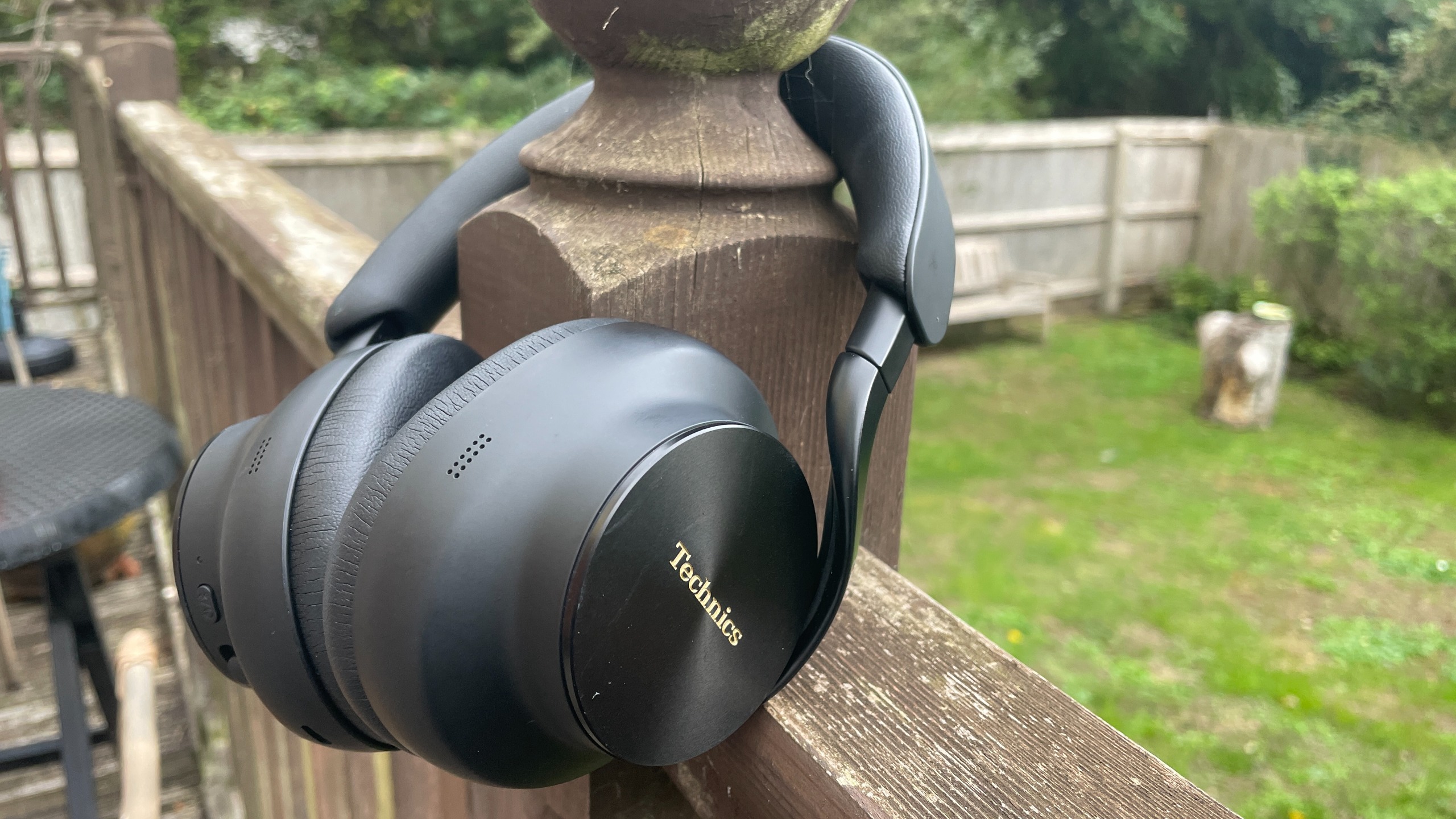 Technics EAH-A1000 headphones in black, in a garden