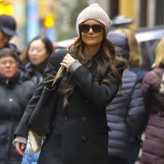 Katie Holmes wears red trousers.