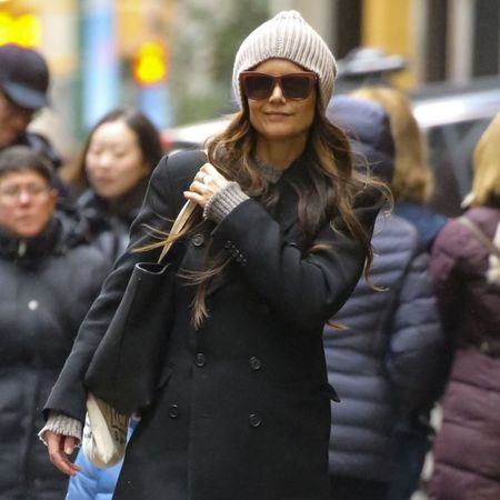 Katie Holmes wears red trousers.