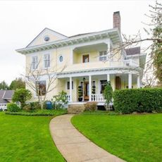 cream house with lawn in front yard