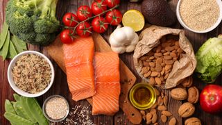 Assorted vegetable, salmon and fruit on a wooden table