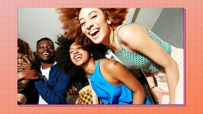 group of young Black women at a party smiling to the camera