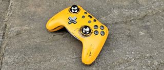 A yellow metal controller with mirrored sticks