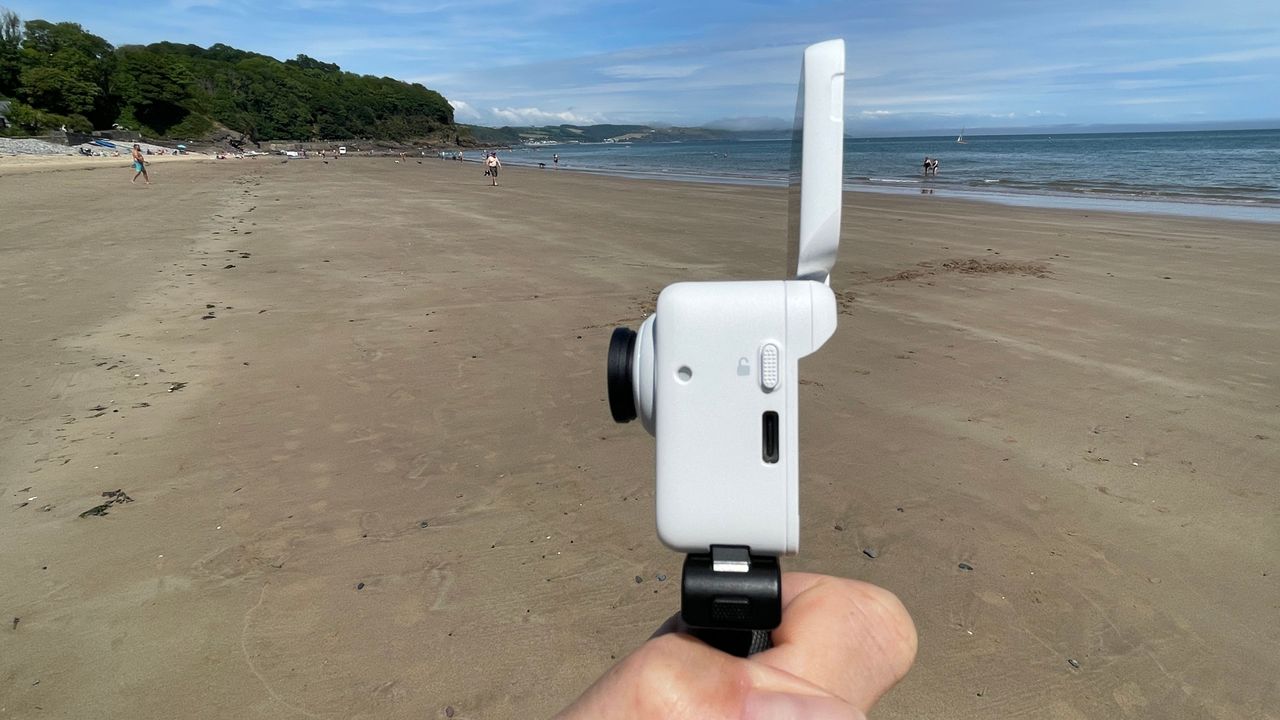 Insta360 GO 3 action camera on a beach
