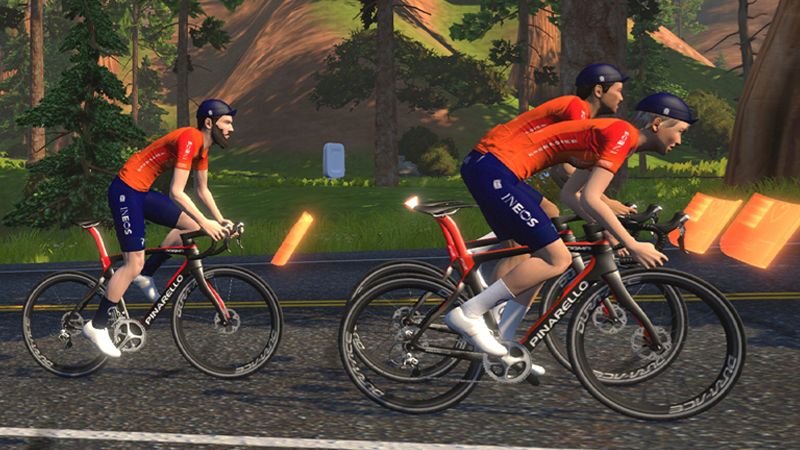 Three Ineos Grenadiers rider avatars ride up a hill on Zwift