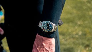 Man wearing Elliot Brown Bloxworth Heritage Diver watch over a wetsuit