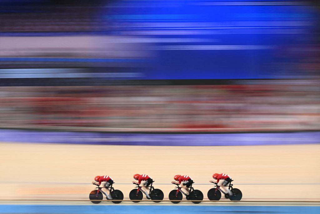 Team Denmark Denmark's Tobias Aagaard Hansen, Denmark's Niklas Larsen, Denmark's Carl-Frederik Bevort and Denmark's Rasmus Lund Pedersen compete in a men's track cycling team pursuit qualifying round of the Paris 2024 Olympic Games at the Saint-Quentin-en-Yvelines National Velodrome in Montigny-le-Bretonneux, south-west of Paris, on August 5, 2024. (Photo by SEBASTIEN BOZON / AFP)