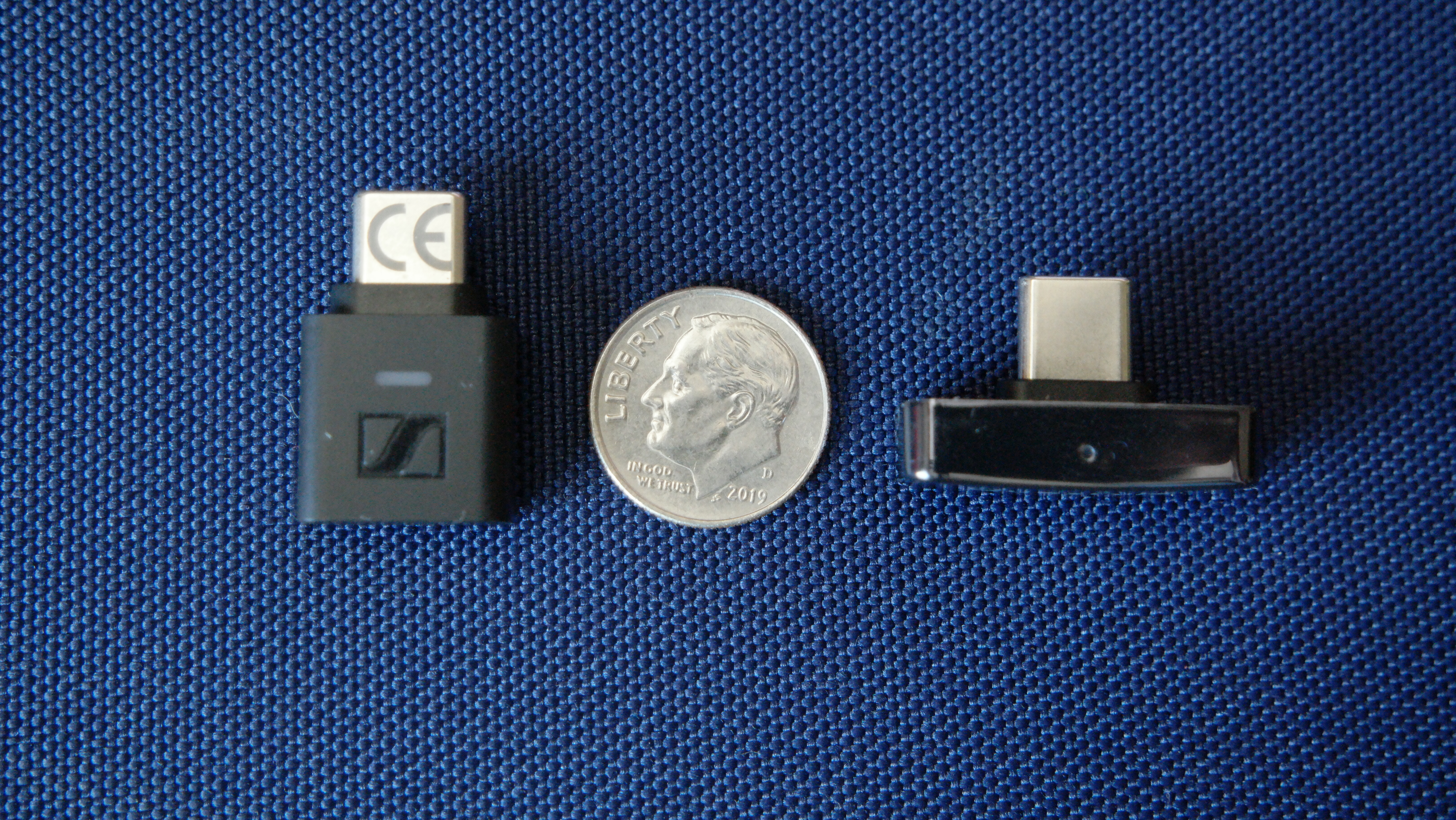 A dime, surrounded by the Sennheiser BTD 700 and Questyle QCC Dongle Pro