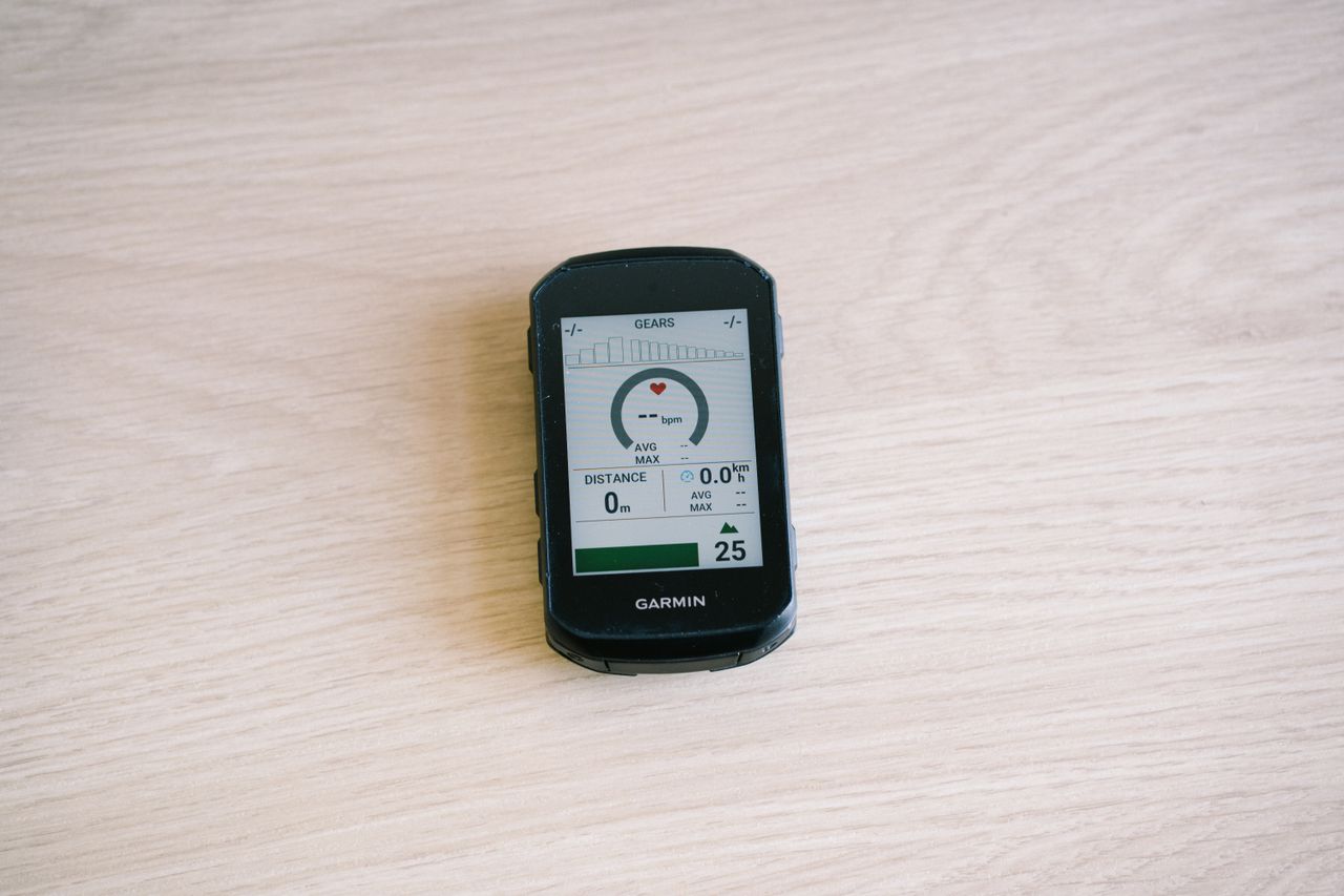 Bike computers on a table top showing different data screens