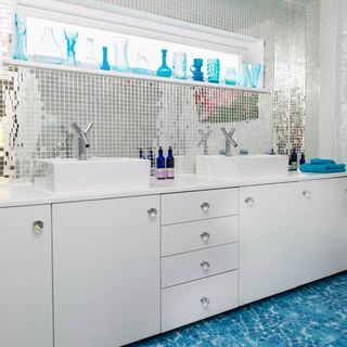 bathroom with white block design white cabinet and blue designed flooring