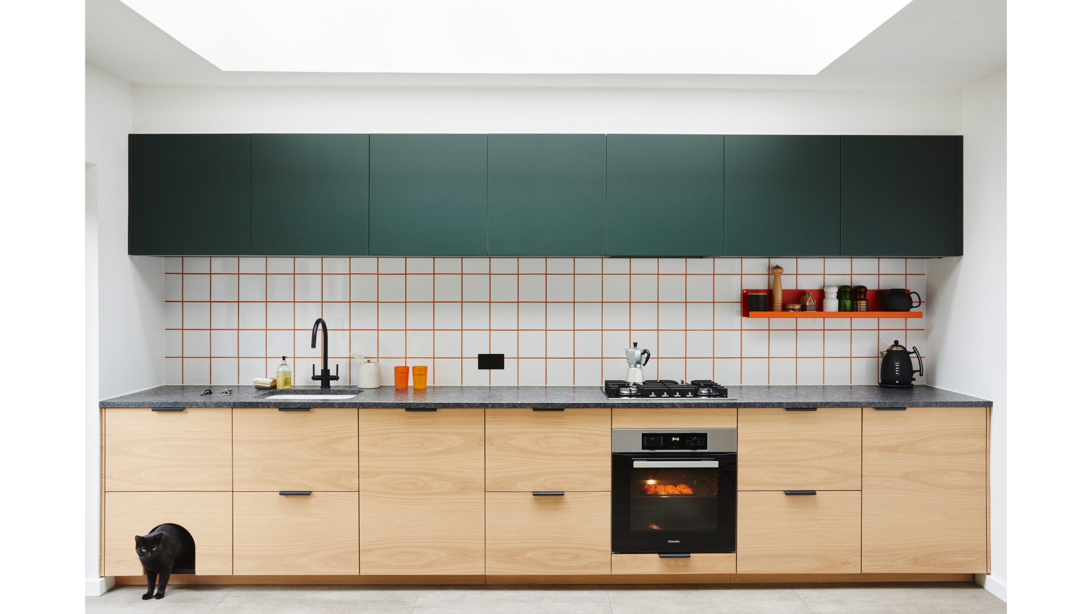 a wood kitchen with a gridded backsplash, a small cat nap nook is in the bottom left corner