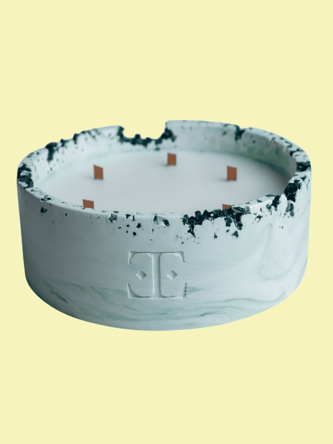 A blue wood wick candle with a spiced apple scent from Esti Living