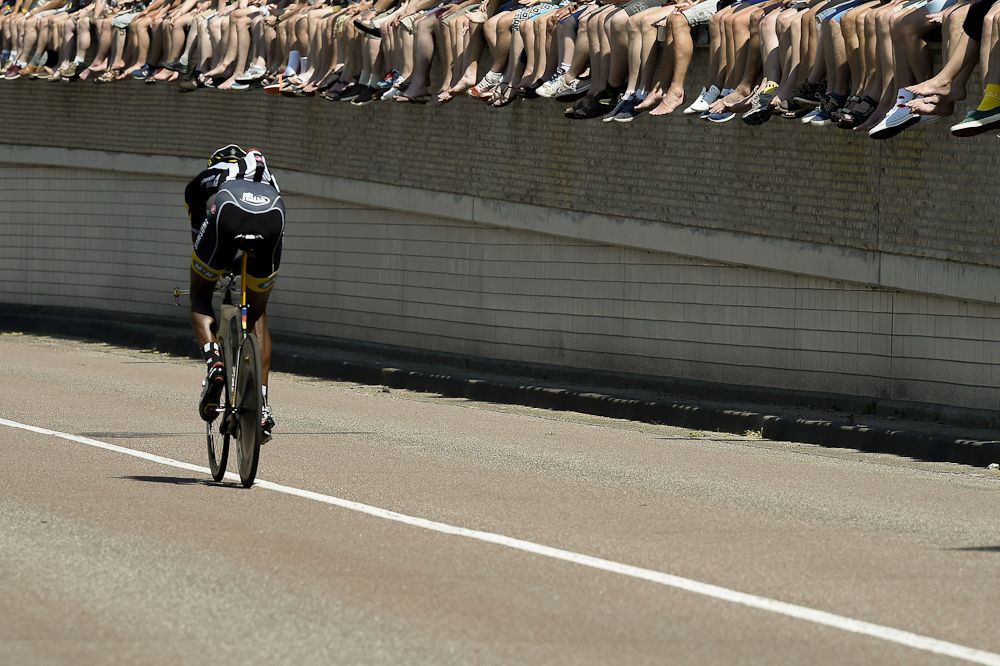 Eritrea's Daniel Teklehaimanot (MTN-Qhubeka) rides along a line of fans seated for the stage.