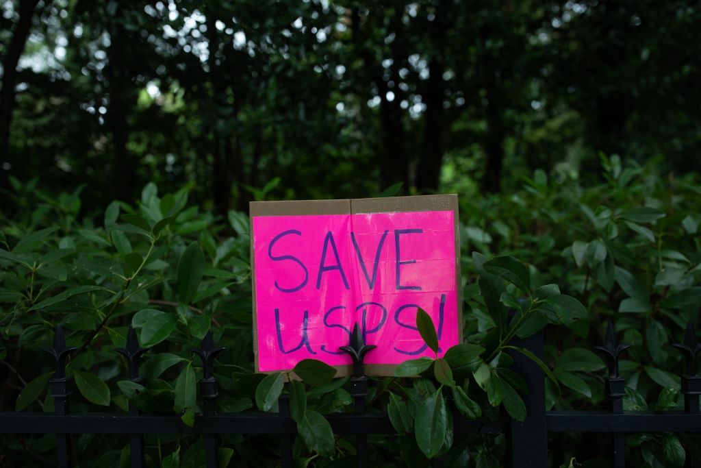 A sign left outside Postmaster General Louis DeJoy&amp;#039;s house