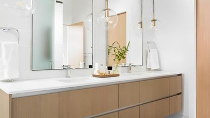 A white bathroom countertop on wooden units